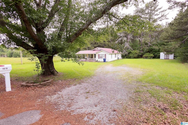 1619 Websters Chapel Rd, Wellington, AL 36279 - view of front facade with a front lawn, a porch, a shed, an outbuilding, and driveway