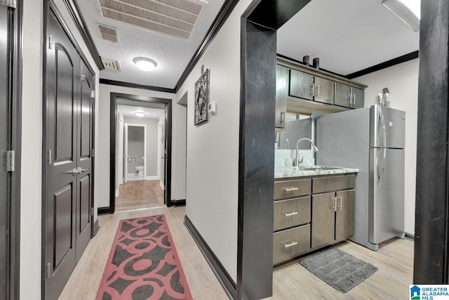 4150 County Highway 13, Locust Fork, AL 35097 - hall with ornamental molding, a sink, light wood-style floors, baseboards, and a textured ceiling