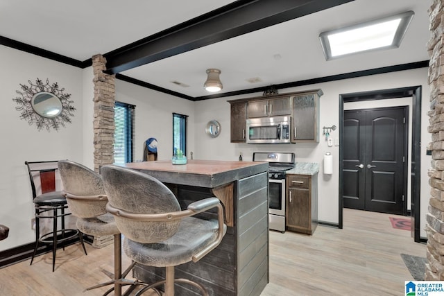 4150 County Highway 13, Locust Fork, AL 35097 - kitchen featuring appliances with stainless steel finishes, ornamental molding, light wood-type flooring, dark brown cabinets, and baseboards
