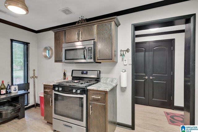 4150 County Highway 13, Locust Fork, AL 35097 - kitchen featuring stainless steel appliances, light wood-style flooring, baseboards, light countertops, and crown molding