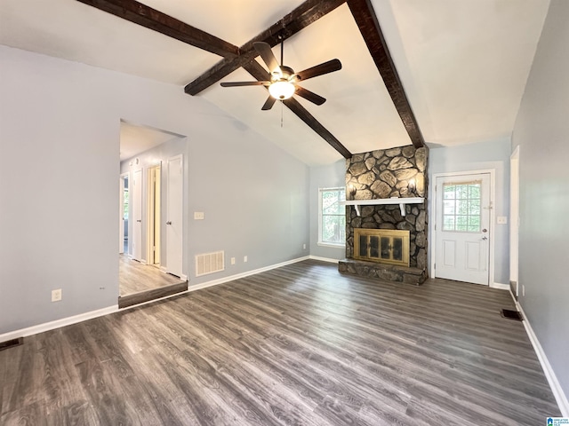 unfurnished living room with plenty of natural light, wood finished floors, a ceiling fan, and a fireplace