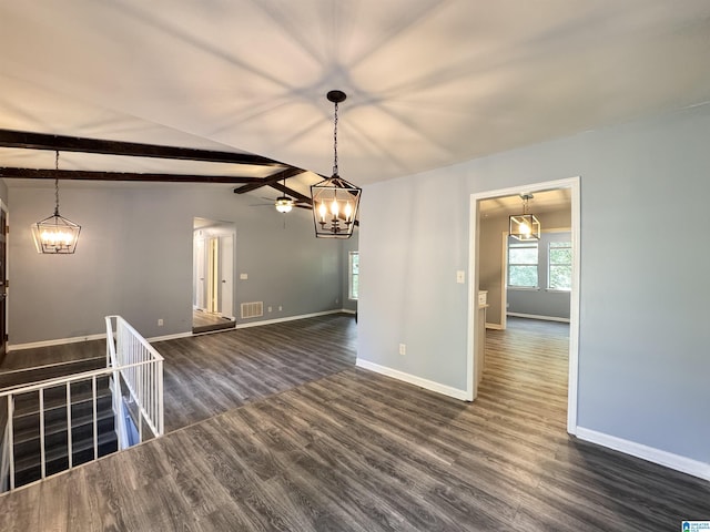 empty room featuring dark wood-style flooring, baseboards, and a chandelier
