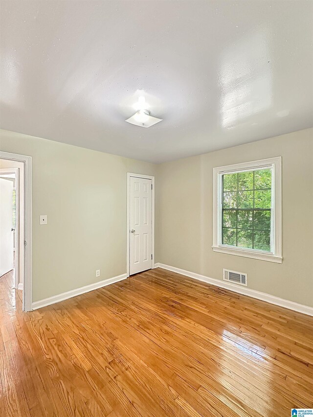 spare room featuring light wood-style flooring and baseboards