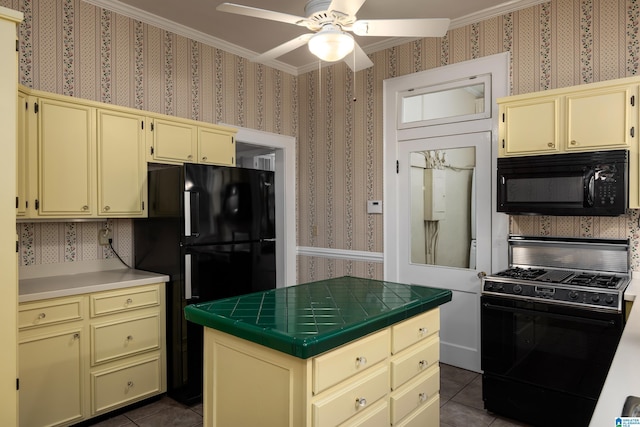 1479 Milner Cres S, Birmingham, AL 35205 - kitchen with black appliances, cream cabinets, tile countertops, wallpapered walls, and ceiling fan