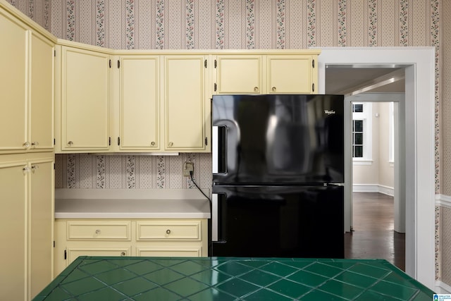 1479 Milner Cres S, Birmingham, AL 35205 - kitchen featuring cream cabinets, freestanding refrigerator, wallpapered walls, and dark wood-style floors