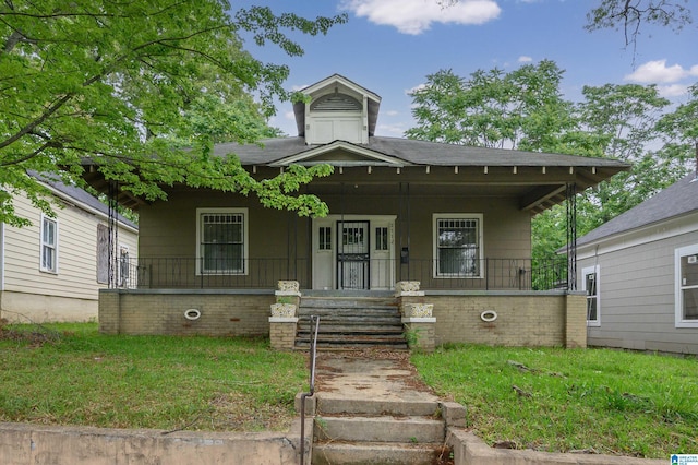 view of front of house with a porch and a front yard