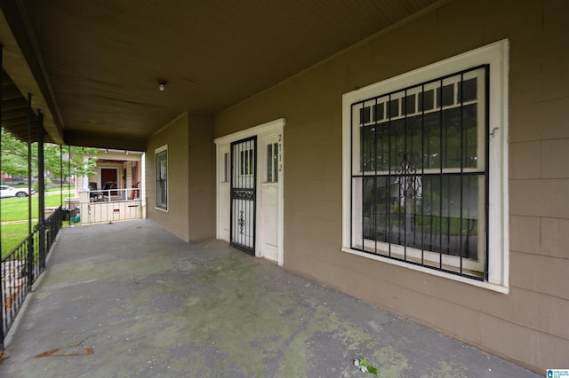 view of patio / terrace with a porch and a carport