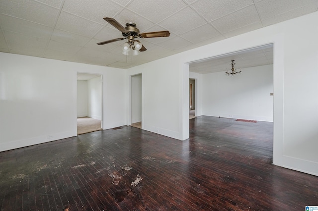 spare room featuring hardwood / wood-style floors, a ceiling fan, a paneled ceiling, and baseboards