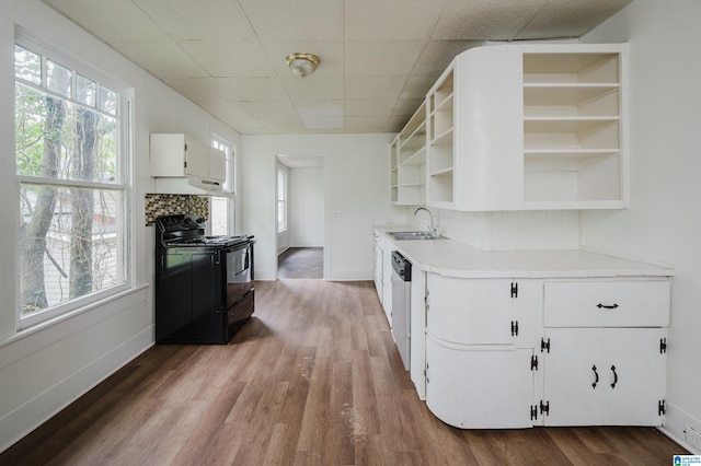 kitchen with open shelves, black range, a sink, white cabinets, and wood finished floors