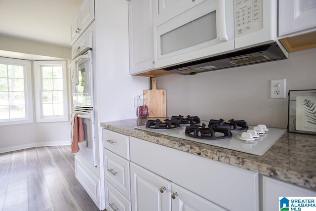 105 Mountain View Ln, Springville, AL 35146 - kitchen with white appliances, white cabinetry, baseboards, light wood-type flooring, and light stone counters
