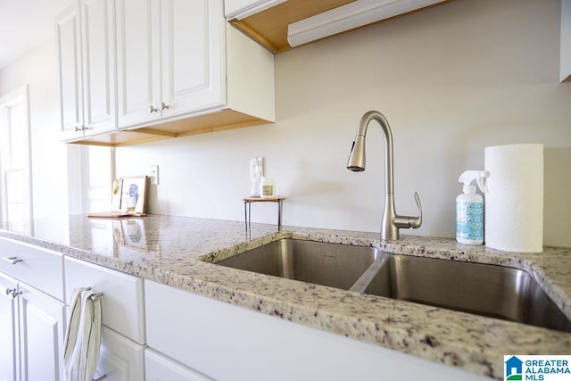 105 Mountain View Ln, Springville, AL 35146 - kitchen view of a sink, white cabinets, and light stone counters
