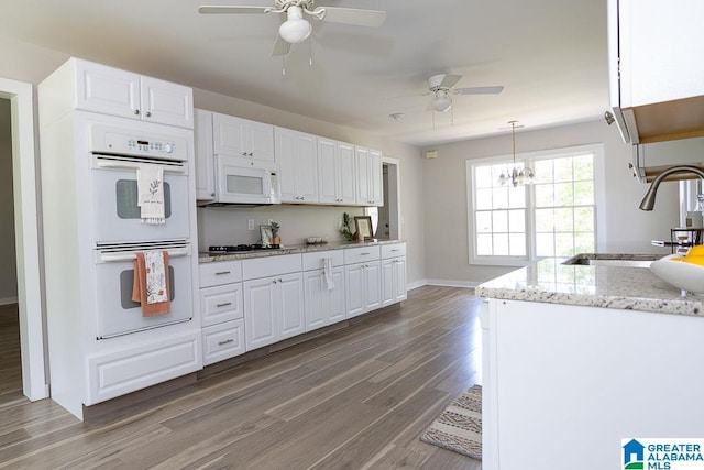 105 Mountain View Ln, Springville, AL 35146 - kitchen featuring white appliances, ceiling fan, light wood-type flooring, a sink, and white cabinetry