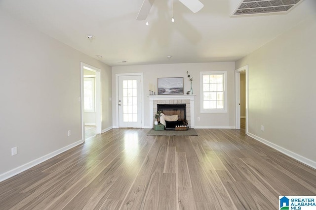 105 Mountain View Ln, Springville, AL 35146 - unfurnished living room featuring a ceiling fan, wood finished floors, a fireplace, and baseboards