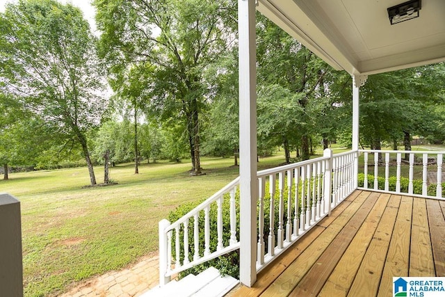 105 Mountain View Ln, Springville, AL 35146 - wooden porch featuring view of scattered trees and a lawn
