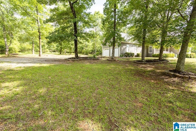 105 Mountain View Ln, Springville, AL 35146 - view of grassy yard featuring an attached garage