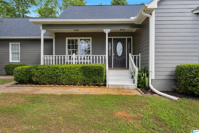 105 Mountain View Ln, Springville, AL 35146 - property entrance featuring a lawn, covered porch, and a shingled roof