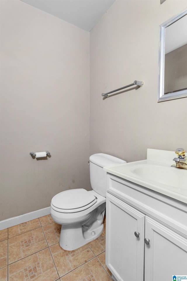 105 Mountain View Ln, Springville, AL 35146 - half bathroom featuring toilet, vanity, baseboards, and tile patterned flooring