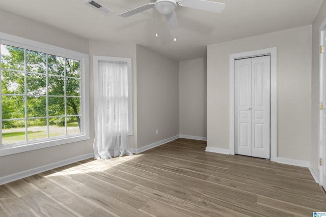 105 Mountain View Ln, Springville, AL 35146 - unfurnished bedroom featuring baseboards, multiple windows, light wood-style flooring, and a closet