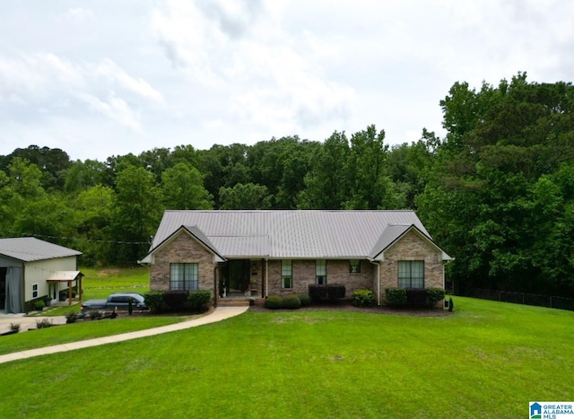 3455 Self Creek Rd, Warrior, AL 35180 - ranch-style house featuring metal roof, a view of trees, and brick siding
