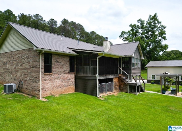 3455 Self Creek Rd, Warrior, AL 35180 - rear view of property featuring a sunroom, a chimney, central AC, brick siding, and a yard