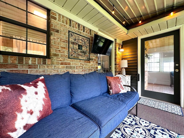 3455 Self Creek Rd, Warrior, AL 35180 - carpeted living room featuring brick wall