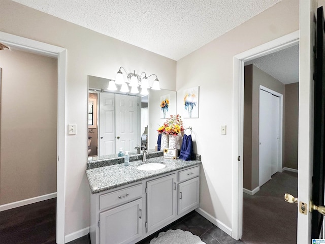 3455 Self Creek Rd, Warrior, AL 35180 - bathroom with a textured ceiling, vanity, and baseboards