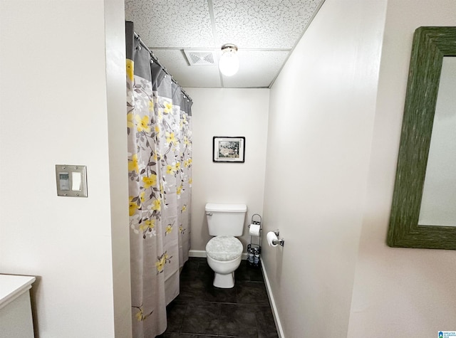 3455 Self Creek Rd, Warrior, AL 35180 - full bath featuring a drop ceiling, toilet, baseboards, and tile patterned floors