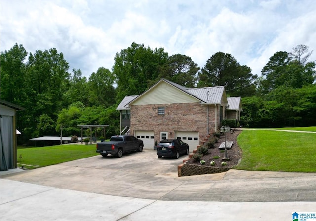 3455 Self Creek Rd, Warrior, AL 35180 - view of side of home featuring an attached garage, concrete driveway, a yard, and brick siding