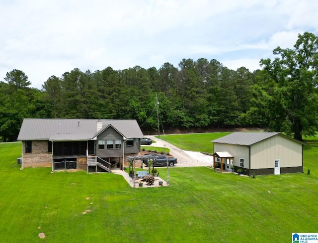 3455 Self Creek Rd, Warrior, AL 35180 - back of property with a yard, metal roof, and a forest view
