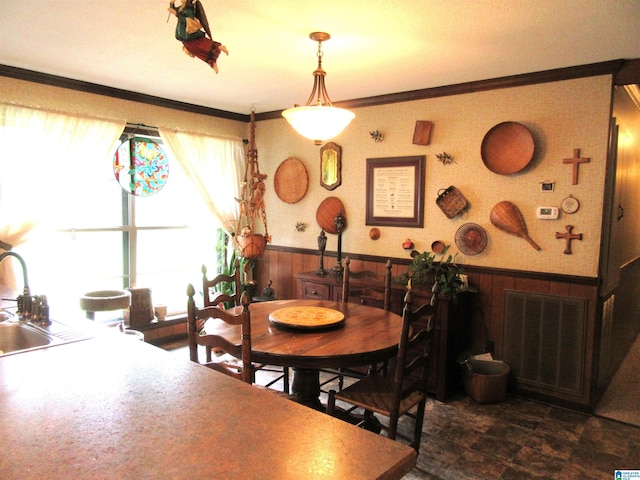 3212 County Road 730, Cullman, AL 35055 - dining space with a wainscoted wall, wood walls, crown molding, and dark stone finish floors