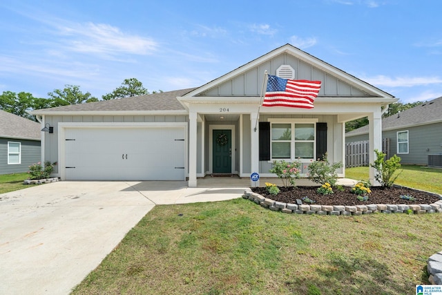 204 Koslin Loop, Calera, AL 35040 - view of front of home with board and batten siding, an attached garage, driveway, a front lawn, and a porch