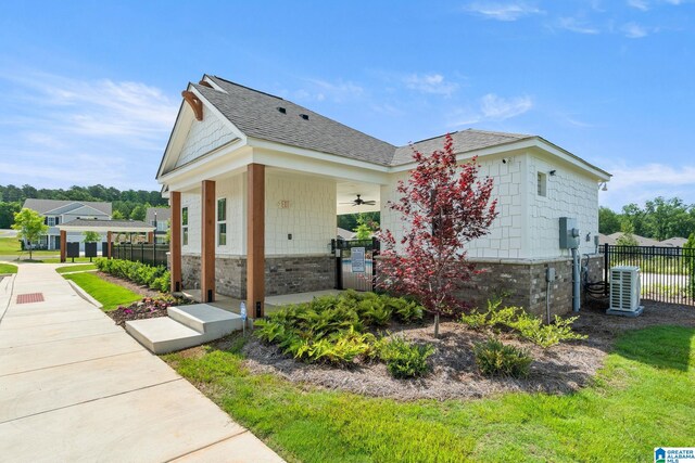 204 Koslin Loop, Calera, AL 35040 - view of side of home featuring a ceiling fan, roof with shingles, central AC unit, and stone siding