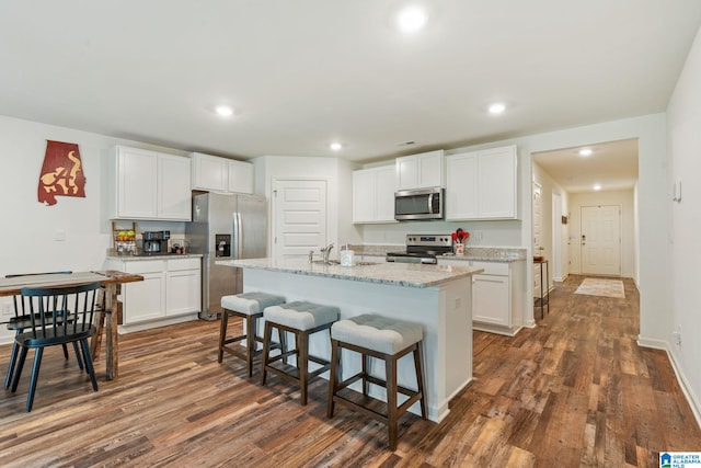 204 Koslin Loop, Calera, AL 35040 - kitchen featuring stainless steel appliances, dark wood-type flooring, white cabinetry, recessed lighting, and a kitchen breakfast bar