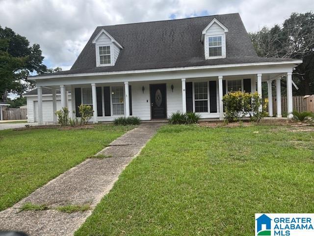 7601 Meadows Dr S, Mobile, AL 36619 - view of front of home featuring a porch, a front yard, and a garage