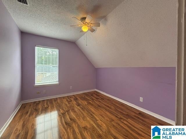 7601 Meadows Dr S, Mobile, AL 36619 - additional living space with a textured ceiling, wood finished floors, a ceiling fan, lofted ceiling, and baseboards