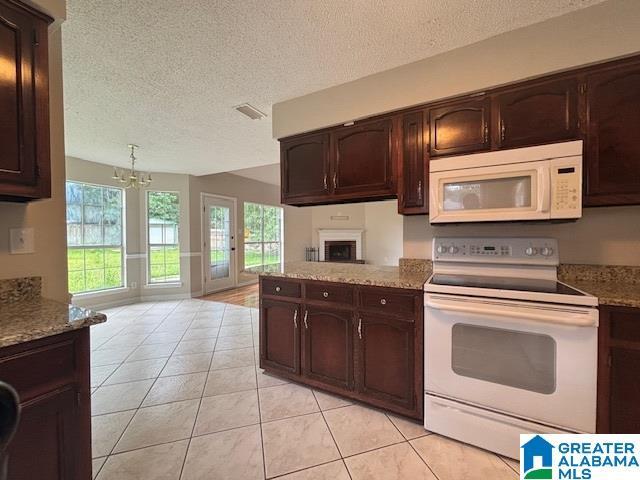 7601 Meadows Dr S, Mobile, AL 36619 - kitchen featuring white appliances, a textured ceiling, open floor plan, light tile patterned floors, and a chandelier