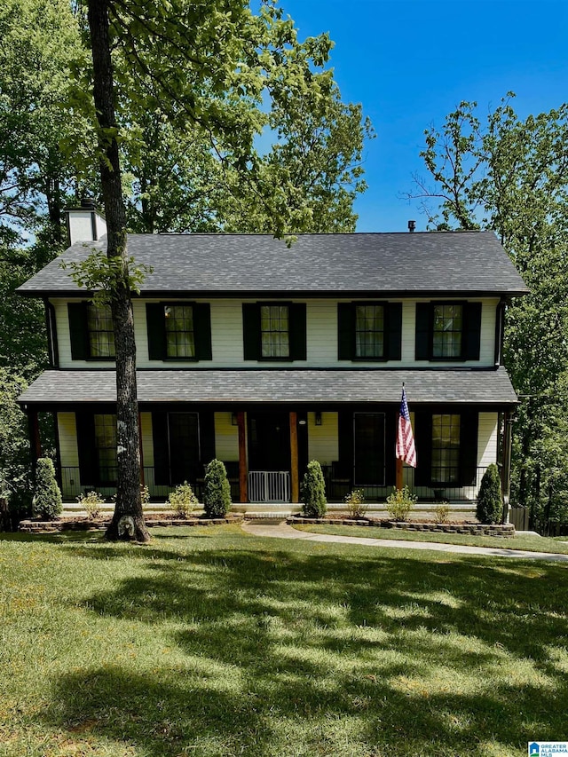 4701 Wooddale Ln, Pelham, AL 35124 - colonial house with covered porch, a chimney, a front yard, and roof with shingles