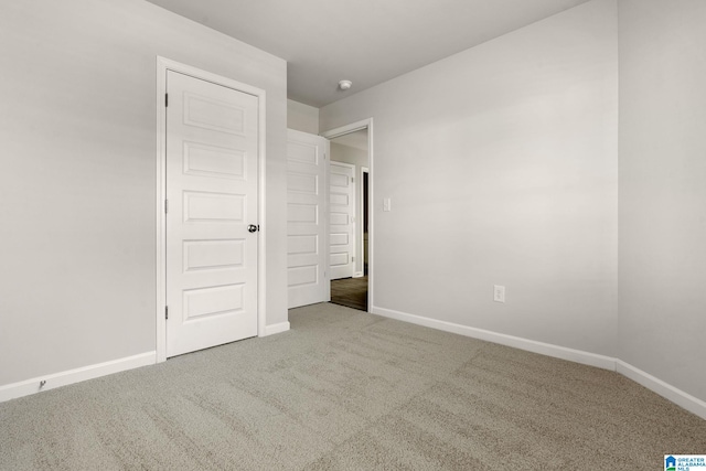 unfurnished bedroom with carpet and baseboards