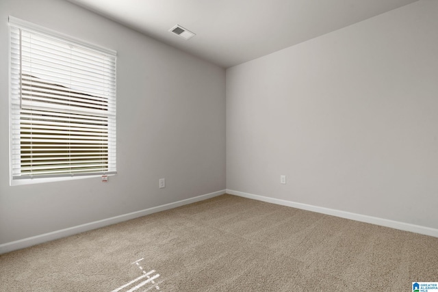 unfurnished room with carpet floors, baseboards, and plenty of natural light