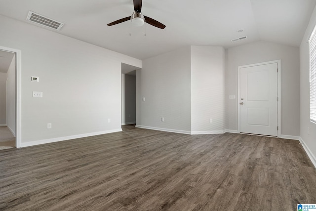 unfurnished living room with ceiling fan, dark wood-type flooring, vaulted ceiling, and baseboards