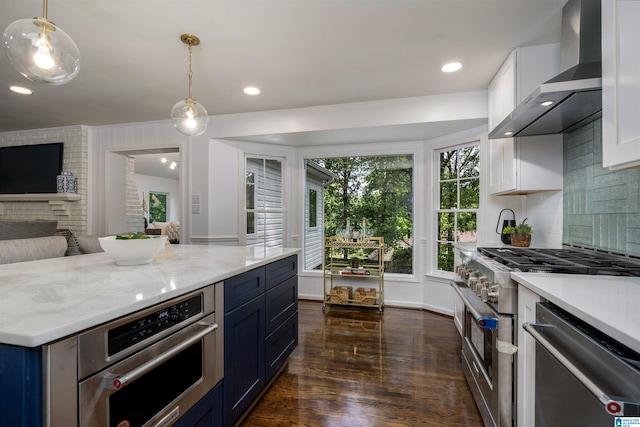 3317 Overton Rd, Mountain Brook, AL 35223 - kitchen featuring wall chimney exhaust hood, appliances with stainless steel finishes, dark wood finished floors, white cabinets, and decorative backsplash