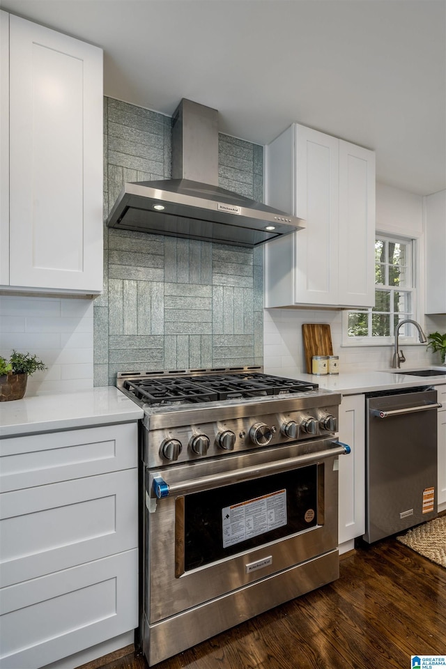 3317 Overton Rd, Mountain Brook, AL 35223 - kitchen featuring stainless steel appliances, wall chimney exhaust hood, a sink, backsplash, and dark wood-style floors