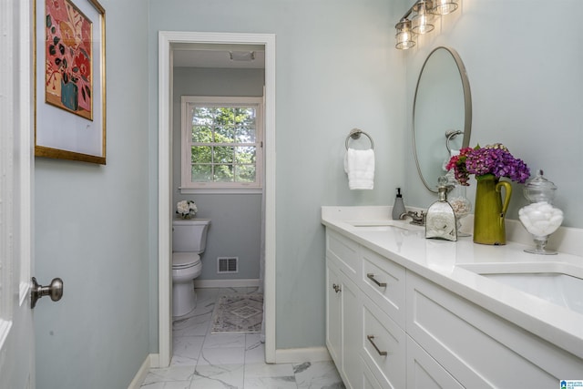 3317 Overton Rd, Mountain Brook, AL 35223 - bathroom with marble look tiles, double vanity, toilet, and baseboards