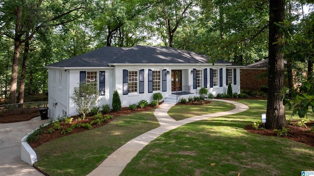 3317 Overton Rd, Mountain Brook, AL 35223 - view of front of house with brick siding, an attached garage, and a front lawn