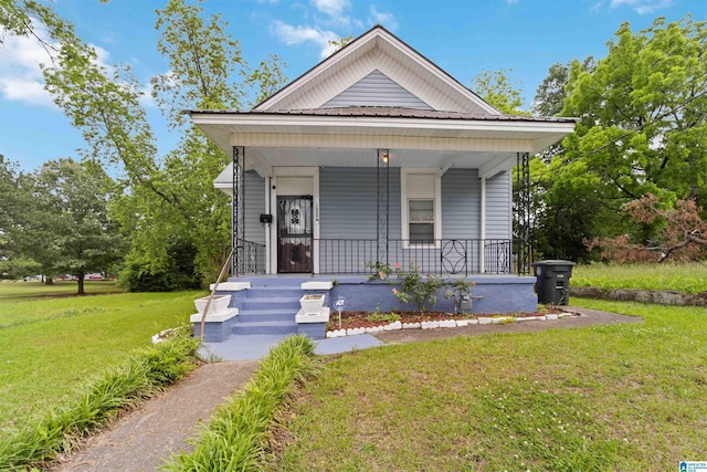 view of front of property with a front yard and covered porch