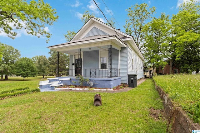 view of front of property with covered porch and a front lawn