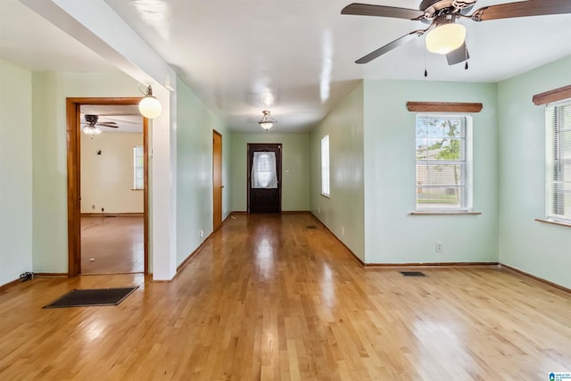 foyer with light wood-style flooring, ceiling fan, and baseboards