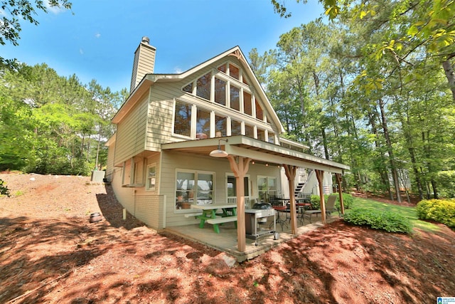 2974 Crescent Crest Dr, Wedowee, AL 36278 - back of property with a chimney, a patio, and stairway