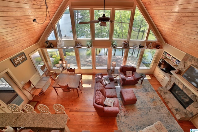 2974 Crescent Crest Dr, Wedowee, AL 36278 - living room featuring high vaulted ceiling, a stone fireplace, plenty of natural light, hardwood / wood-style flooring, and ceiling fan