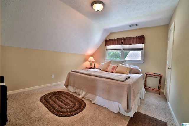 2974 Crescent Crest Dr, Wedowee, AL 36278 - bedroom featuring a textured ceiling, lofted ceiling, carpet floors, and baseboards